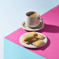 plain shortbread on plate with cup of tea 